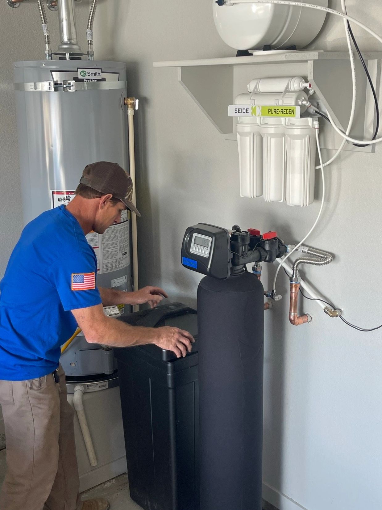 a plumber working on a reverse osmosis and water softener
