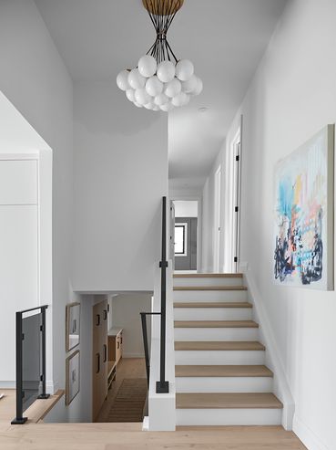 Wooden stairs with a white lamp, offering a stylish design that enhances your home's aesthetic.