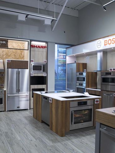 Exhibition display featuring kitchen appliances integrated into custom cabinetry by TKB Group