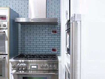 Oven displayed at an exhibition, integrated into custom cabinetry designed and installed by TKB