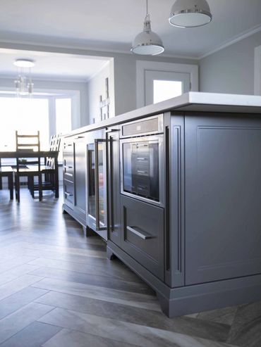 Soft-grey kitchen island with white cabinets, in natural window light, creating a bright design.