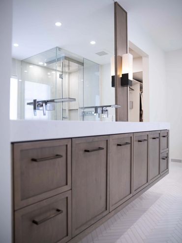 Contemporary bathroom with white and cocoa cabinets, offering a sleek and stylish design.