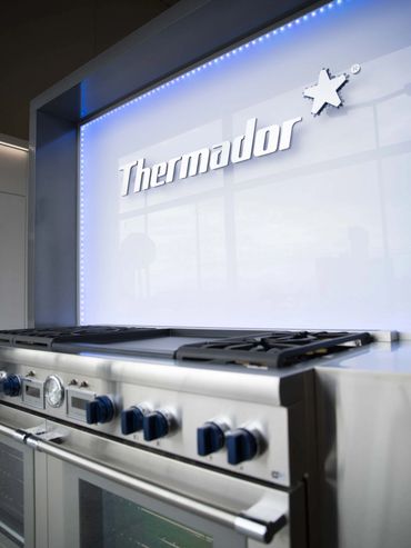 Oven displayed at an exhibition, integrated into custom cabinetry designed and installed by TKB