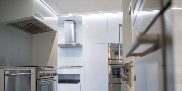 Exhibition display featuring kitchen appliances integrated into custom cabinetry by TKB Group.