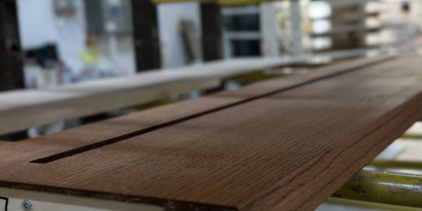 Close-up of a freshly painted wooden piece, ready to become part of a custom furniture made by TKB.