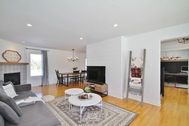 Bright living room with modern furnishings and a cozy fireplace.