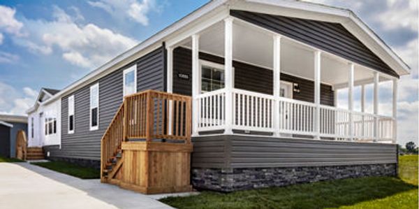 Doublewide Modular Home family room with rustic finishes and open flow to dining area.