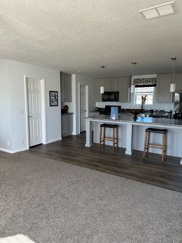 Farmhouse kitchen design in Bristol modular home with modern fixtures and island