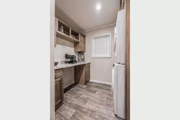 Beautiful sectional home setup with connected deck and landscaped yard