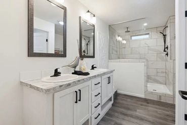 Doublewide home staged for leveling and utility install on-site.