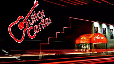 Outdoor wall art installation of musicians by Knight & Bilham hang outside of 200 Guitar Centers .