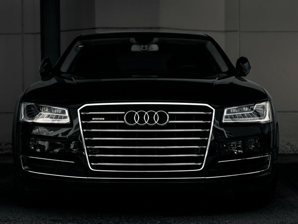Black Audi A8 car in a parking lot.