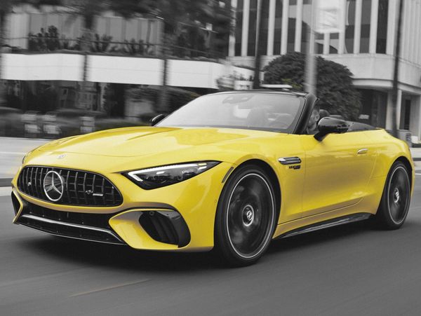 Yellow Mercedes Benz AMG car on the road.