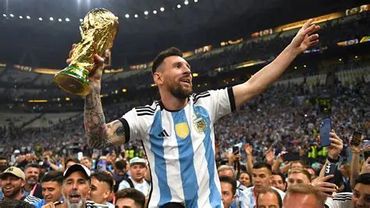 Lionel Messi celebrating with the World Cup trophy.