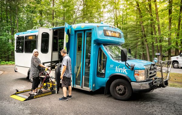 A happy resident boards the bus at Life of Riley Senior Care in Traverse City, MI
