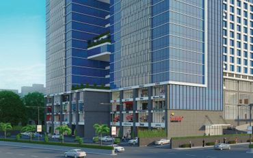 Modern commercial building with luxury brand stores and a glass facade.