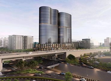 Modern glass skyscraper with curved design overlooking a busy highway interchange.