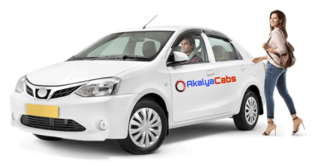 A woman walking towards a white car labeled AkalyaCabs with a driver inside.