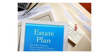 Tablet displaying estate planning documents among file folders and notes.