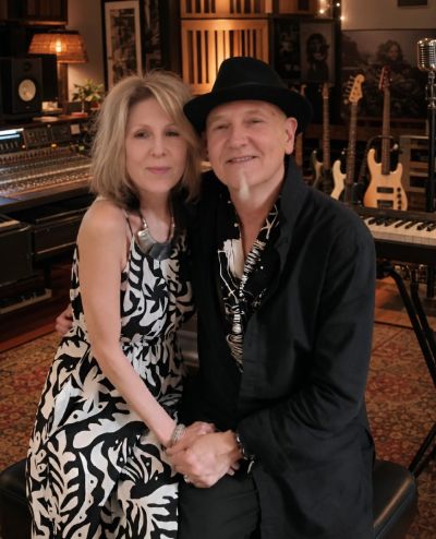 A couple posing in a music studio.