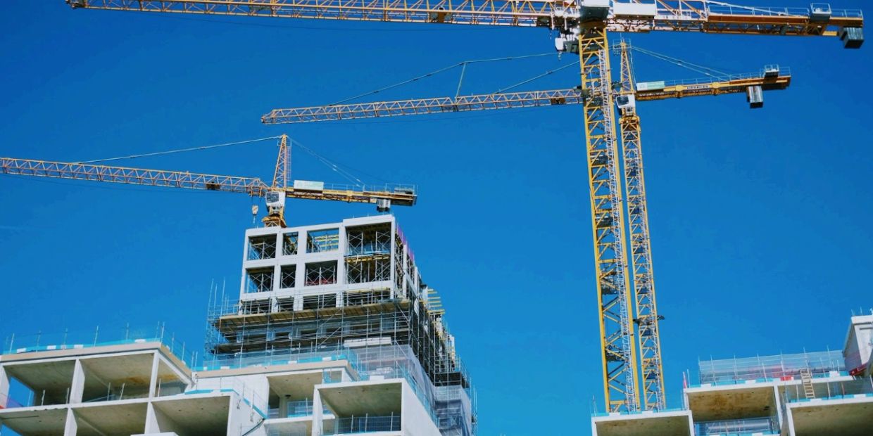 Construction site with cranes and building frames.