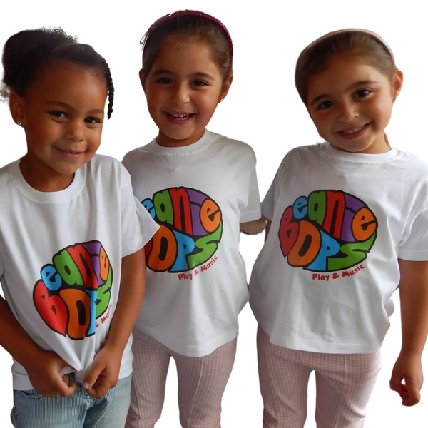 Three smiling children wearing colorful Beanie Bops t-shirts.