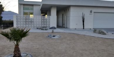 Modern house with desert landscaping and minimalist design.