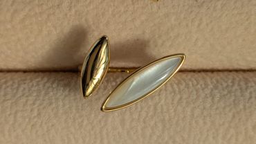 Close-up of an elegant gold and pearl brooch.