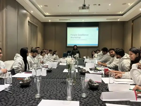 People attending a People Excellence Workshop in a conference room.
