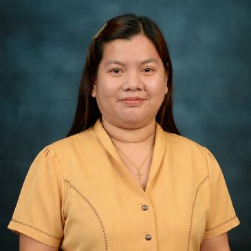Portrait of a woman in a mustard yellow blouse.