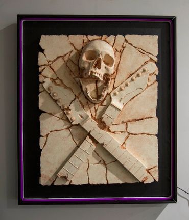 Heavy Rock fossil skull and guitar cross bones. LED lighting and custom framing.