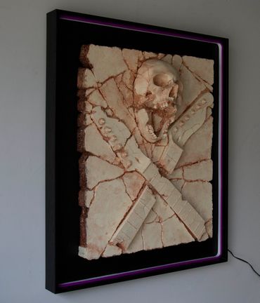 Heavy Rock fossil skull and guitar cross bones. LED lighting and custom framing.
