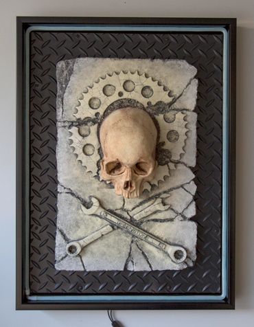 JOLLY WRENCHER fossil skull and wrenches cross bones. LED lighting and custom frame.