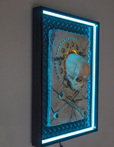 JOLLY WRENCHER fossil skull and wrenches cross bones. LED lighting and custom frame.