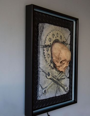 JOLLY WRENCHER fossil skull and wrenches cross bones. LED lighting and custom frame.