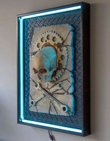 JOLLY WRENCHER fossil skull and wrenches cross bones. LED lighting and custom frame.
