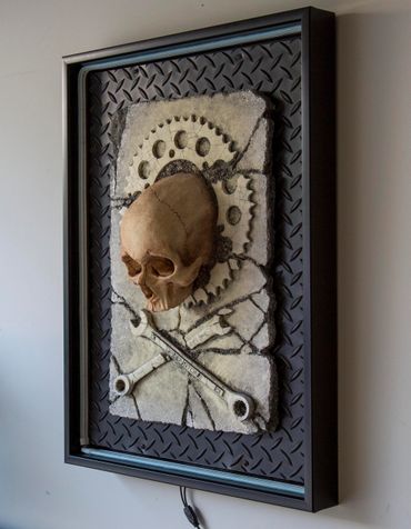 JOLLY WRENCHER fossil skull and wrenches cross bones. LED lighting and custom frame.