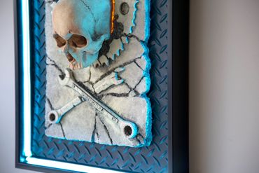 JOLLY WRENCHER fossil skull and wrenches cross bones. LED lighting and custom frame.