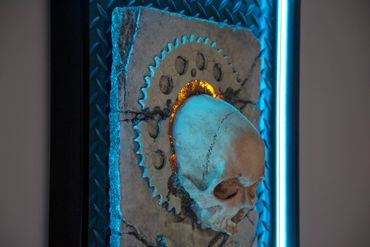JOLLY WRENCHER fossil skull and wrenches cross bones. LED lighting and custom frame.