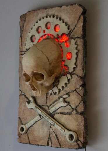 JOLLY WRENCHER fossil skull and wrenches cross bones. LED lighting and irregular edge.