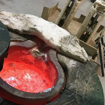 Maker Sculpture Lost Wax Casting Foundry. Crucible filled, ceramic shell moulds ready to pour