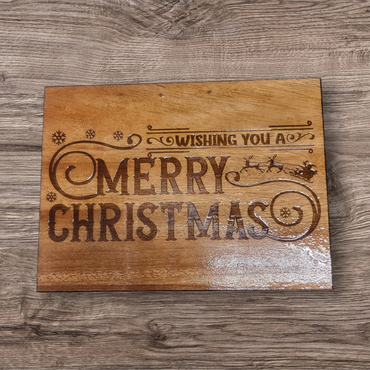 Wooden plaque with 'Wishing You A Merry Christmas' engraved.