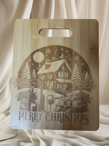Wooden board engraved with a cozy Christmas scene and 'Merry Christmas' text.