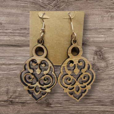 Intricately designed wooden earrings with floral-inspired cutouts.