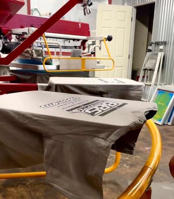 t-shirts on a screen printing machine