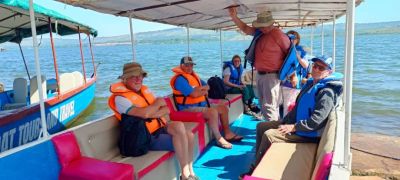 Group of people on a boat wearing life jackets.