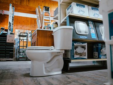 Toilet sitting in the plumbing section for sale