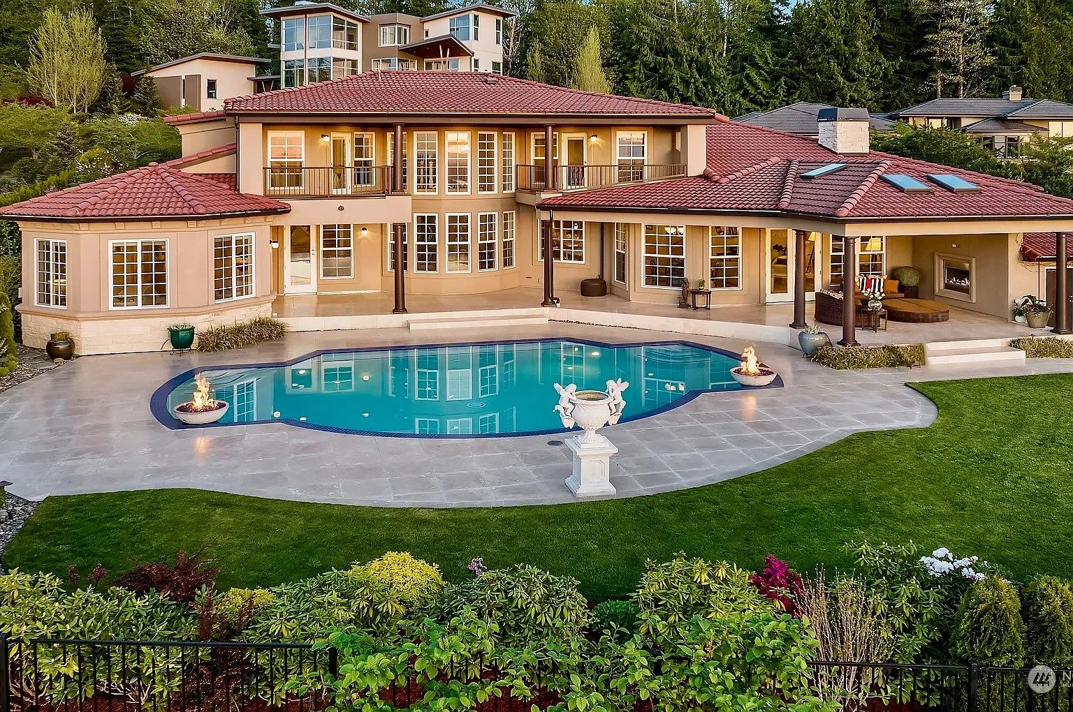 Back of Mediterranean home with pool and gardens