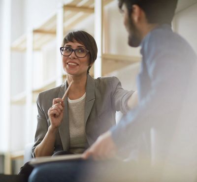 Professional woman talking to man