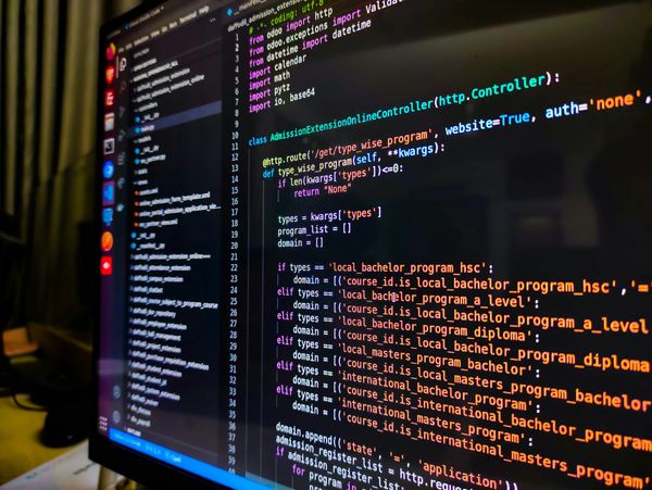 Computer screen displaying Python code for an online admission controller.